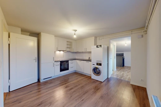 kitchen with white fridge with ice dispenser, hardwood / wood-style floors, oven, and tasteful backsplash