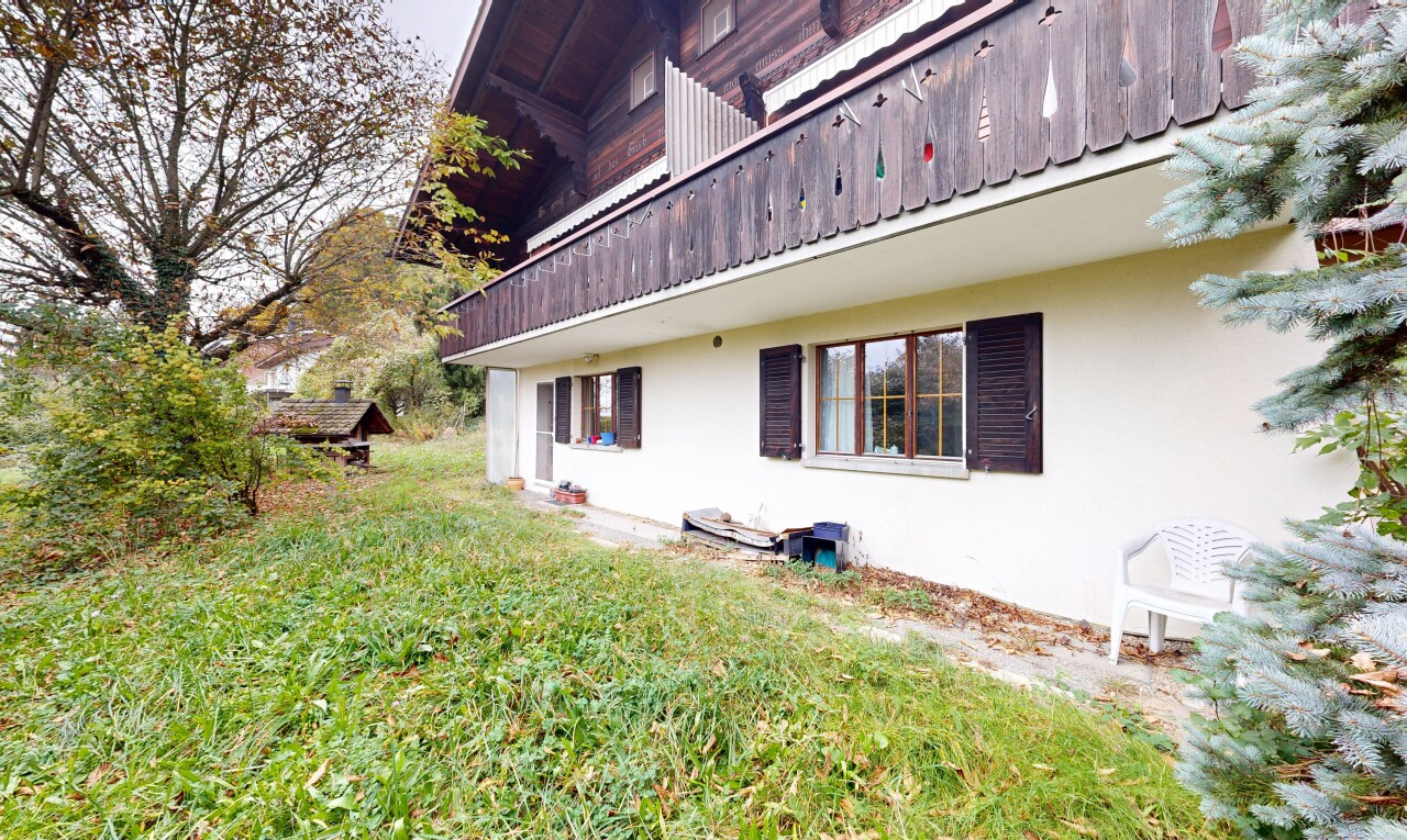 façade avec balcon, bardage en stuc, property visible, pelouse, et overcast