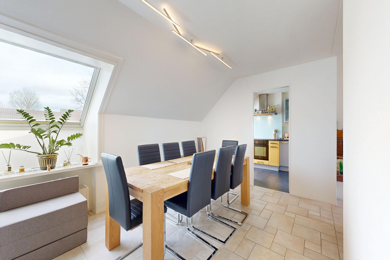 dining area with stone tile flooring and rail lighting