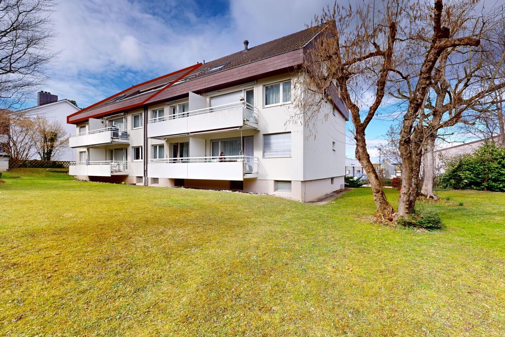 view of property with a yard, stucco siding, and a balcony
