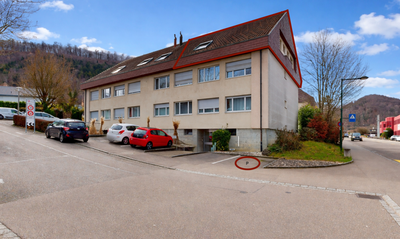 view of apartment building / complex featuring a mountain view and uncovered parking