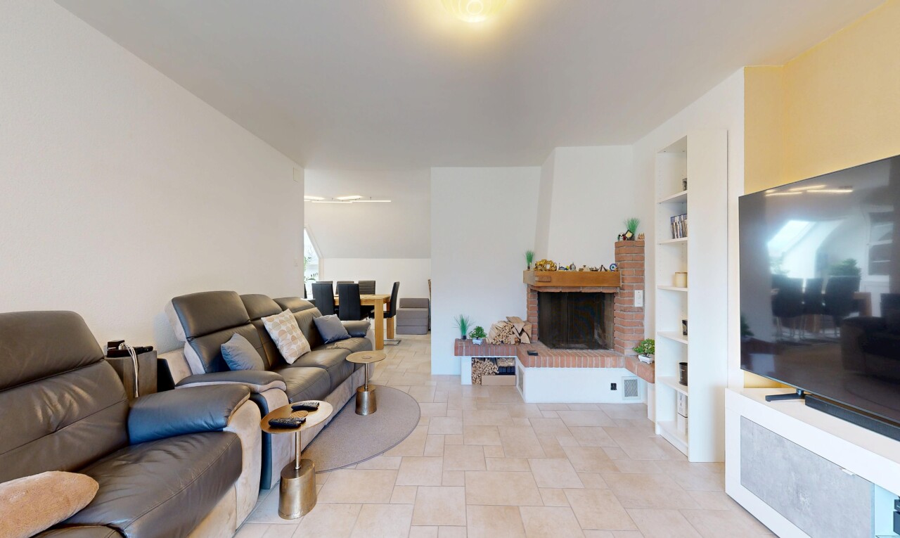 living area with a fireplace and built in shelves