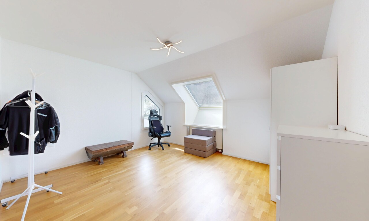 spare room with vaulted ceiling and light wood-style floors