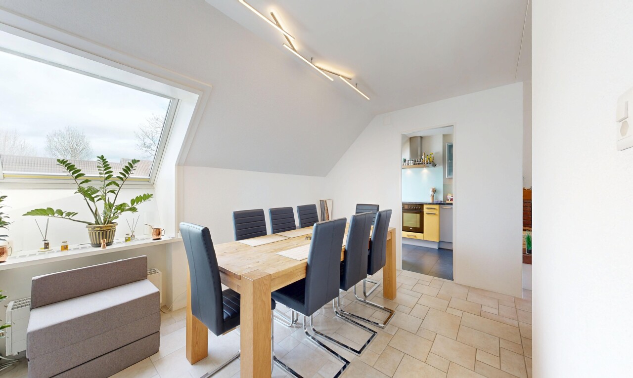 dining area with stone tile flooring and rail lighting