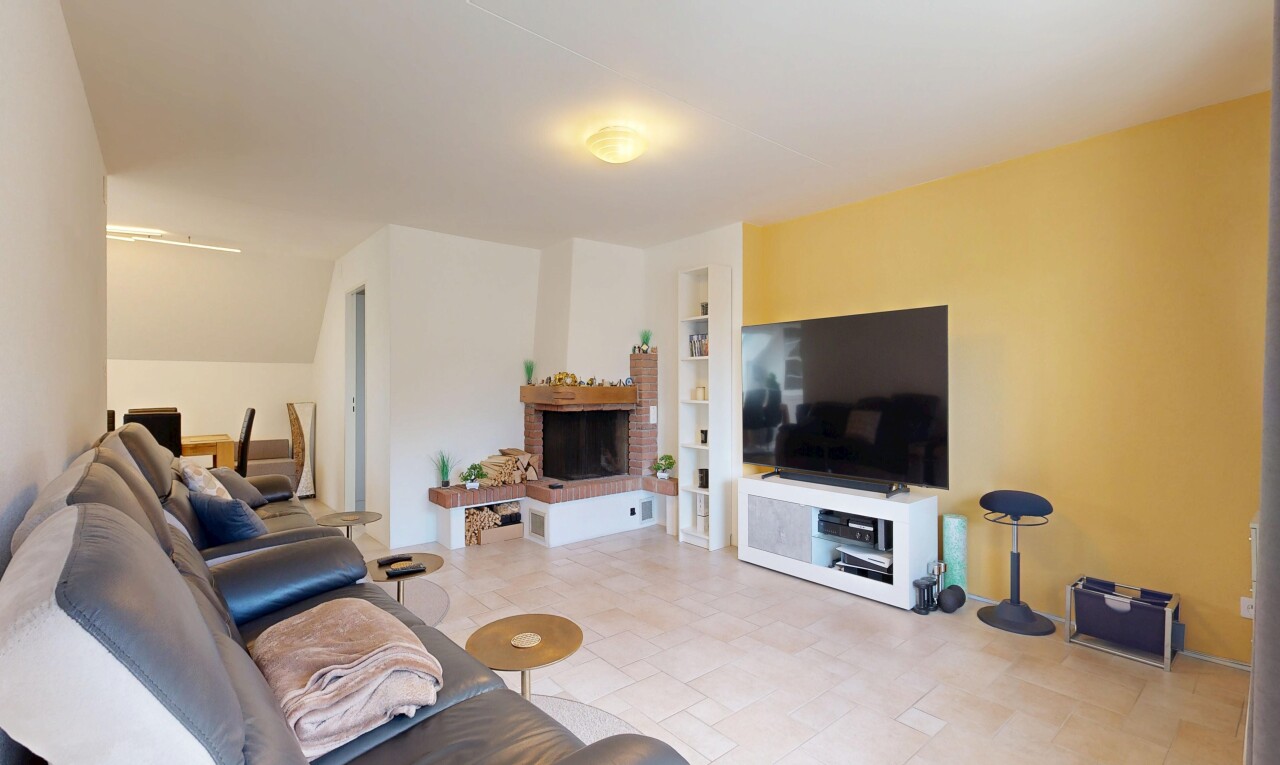 living room with built in features and a brick fireplace