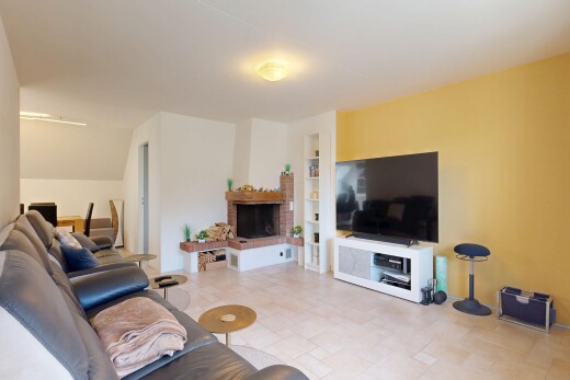 living room with built in features and a brick fireplace