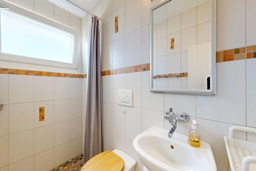 full bath with a shower stall and tile walls