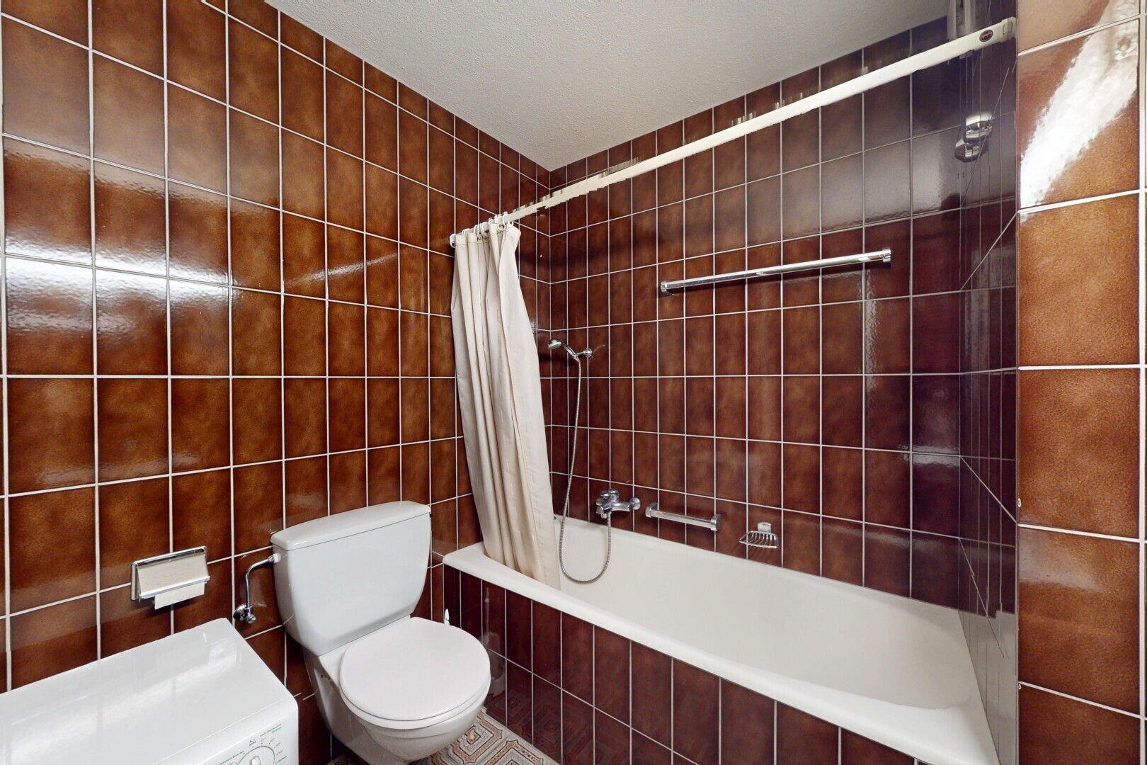 salle de bains avec tile tub, inside property, toilette, mur en carrelage, et tile wall