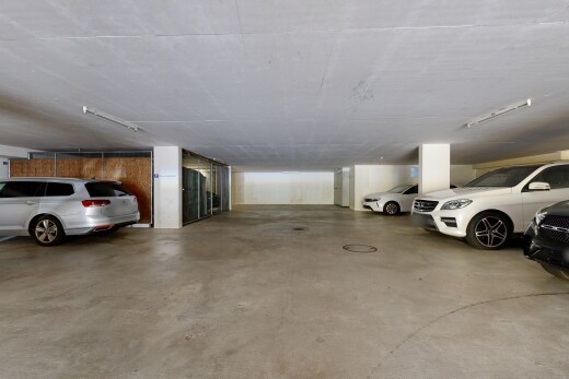 view of parking with a parking deck