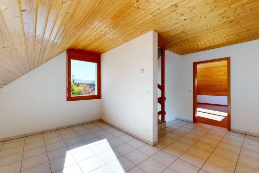 empty room featuring a vaulted wood ceiling and light tile patterned floors