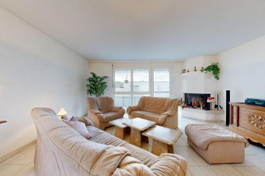 living room with tile patterned floors and a multi sided fireplace