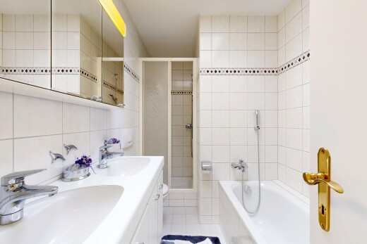 bathroom with tile walls, double vanity, a stall shower, a bath, and light tile patterned flooring