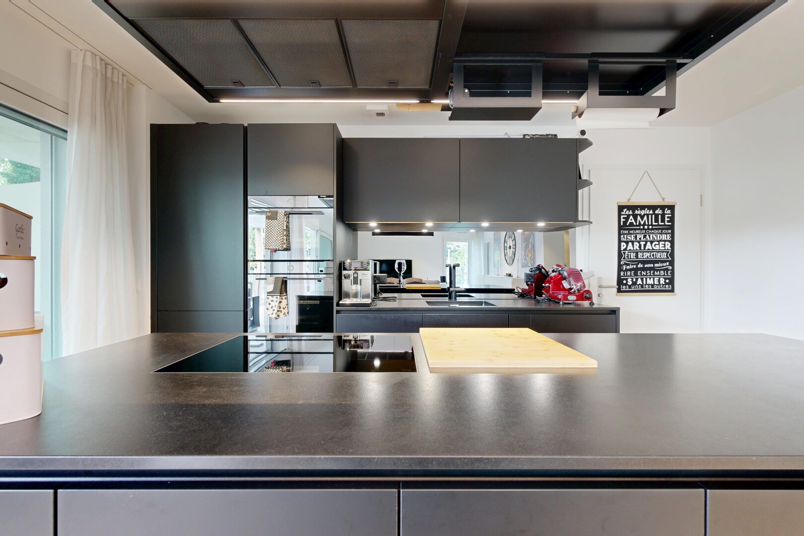 kitchen with dark countertops, double oven, and black electric cooktop