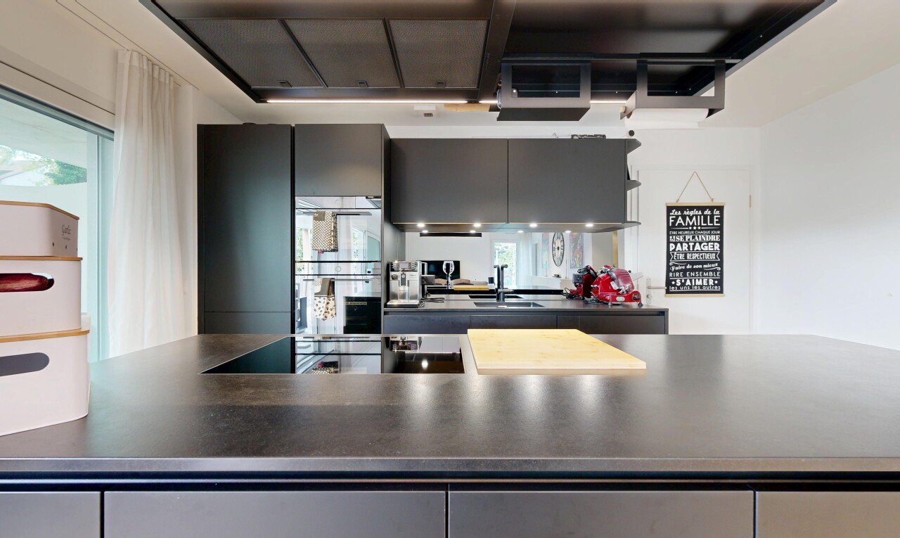 kitchen with dark countertops, double oven, and black electric cooktop