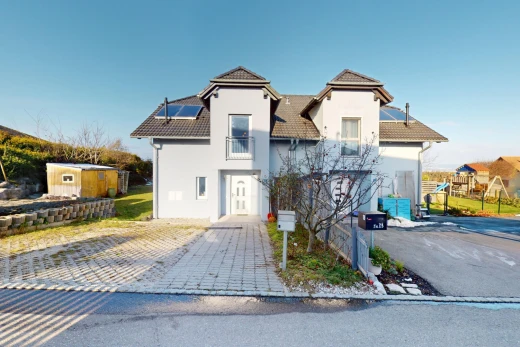 outdoor house featuring solar panels and a storage unit