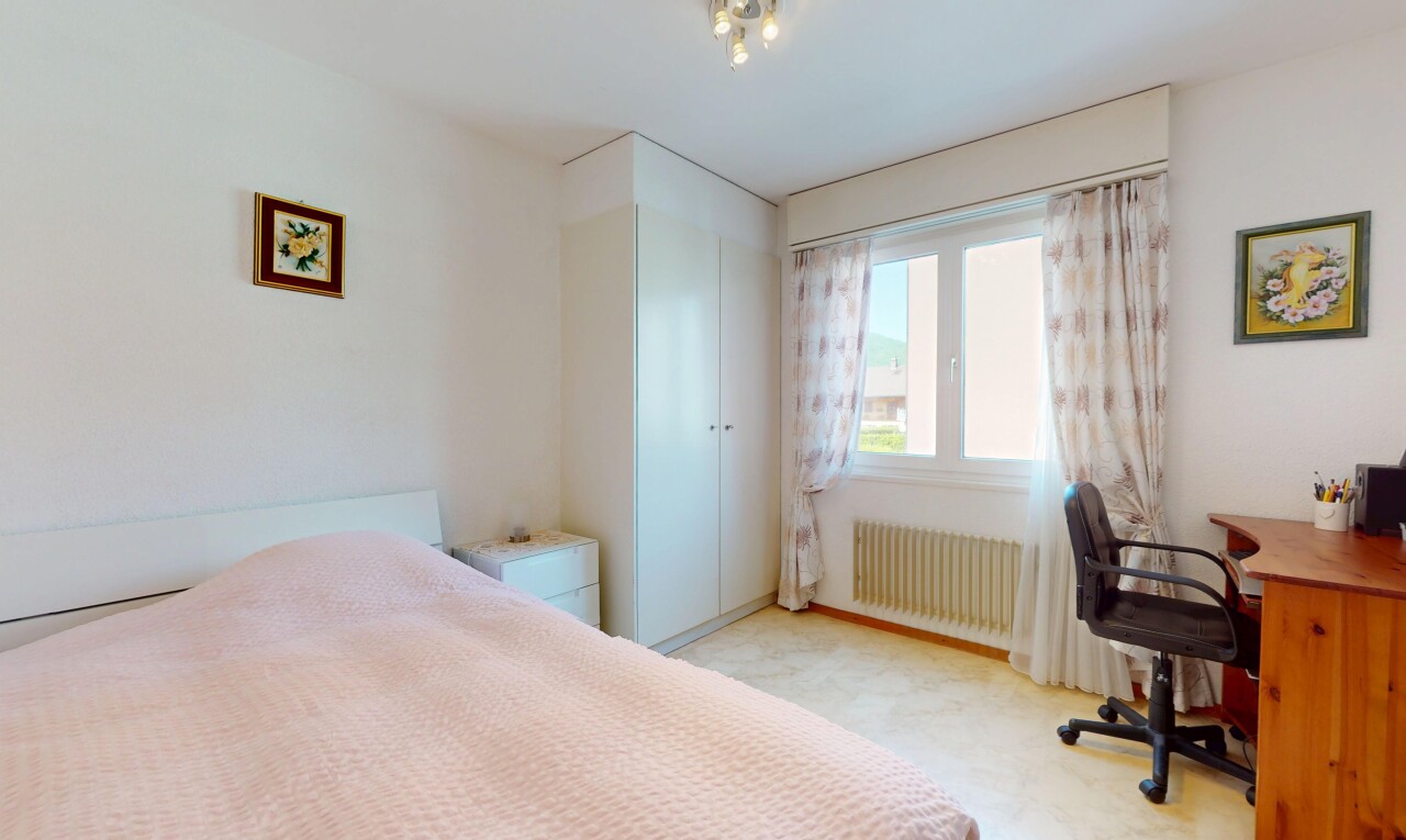 chambre avec espace bureau, radiateur, lumière naturelle, et cloison sèche