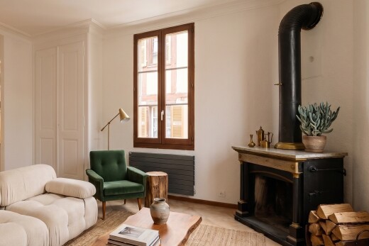 unfurnished room featuring radiator heating unit and a wood stove