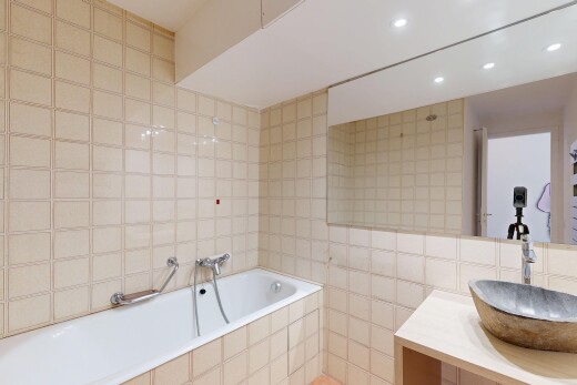 full bathroom featuring tile walls, a garden tub, vanity, and recessed lighting
