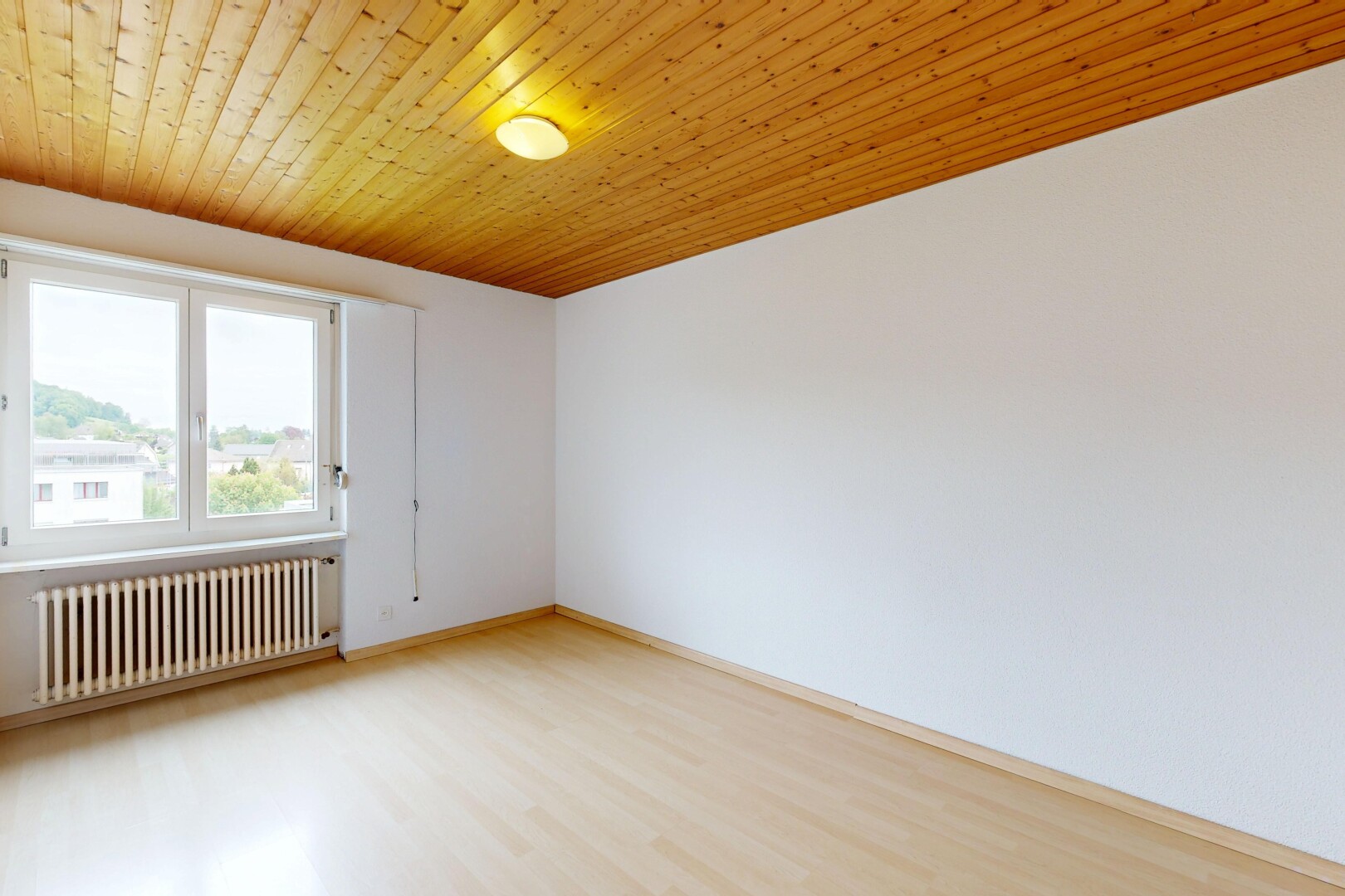 spare room with radiator heating unit, wooden ceiling, and light wood finished floors