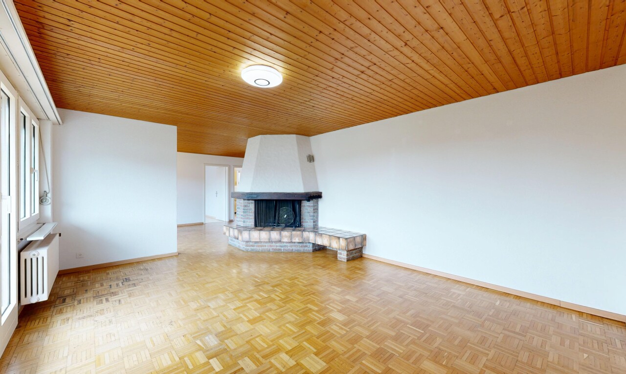 unfurnished living room with parquet flooring, a brick fireplace, wooden ceiling, and radiator heating unit