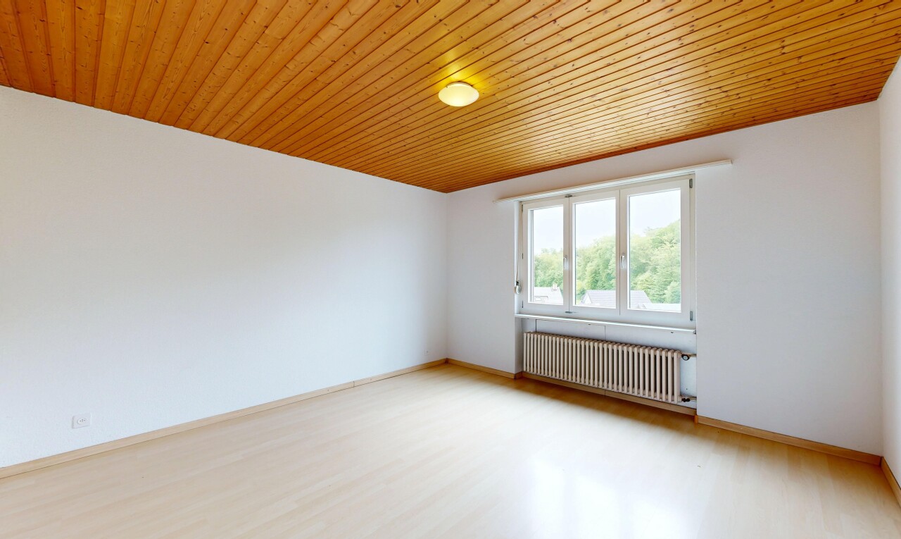 spare room featuring radiator, light wood-style flooring, and wood ceiling