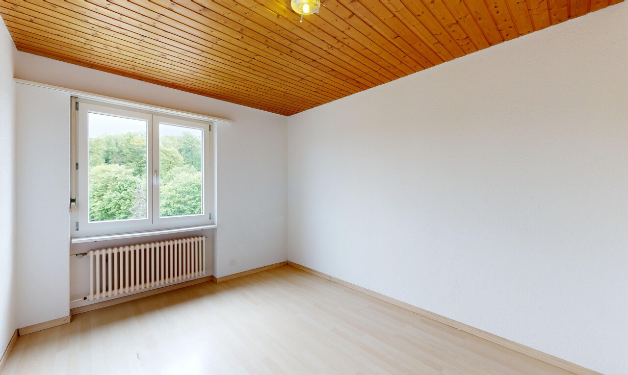 unfurnished room with radiator heating unit, light wood-type flooring, and wood ceiling
