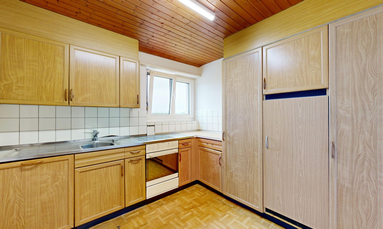 kitchen with stainless steel oven, tasteful backsplash, light wood finish cabinets, wood ceiling, and parquet flooring