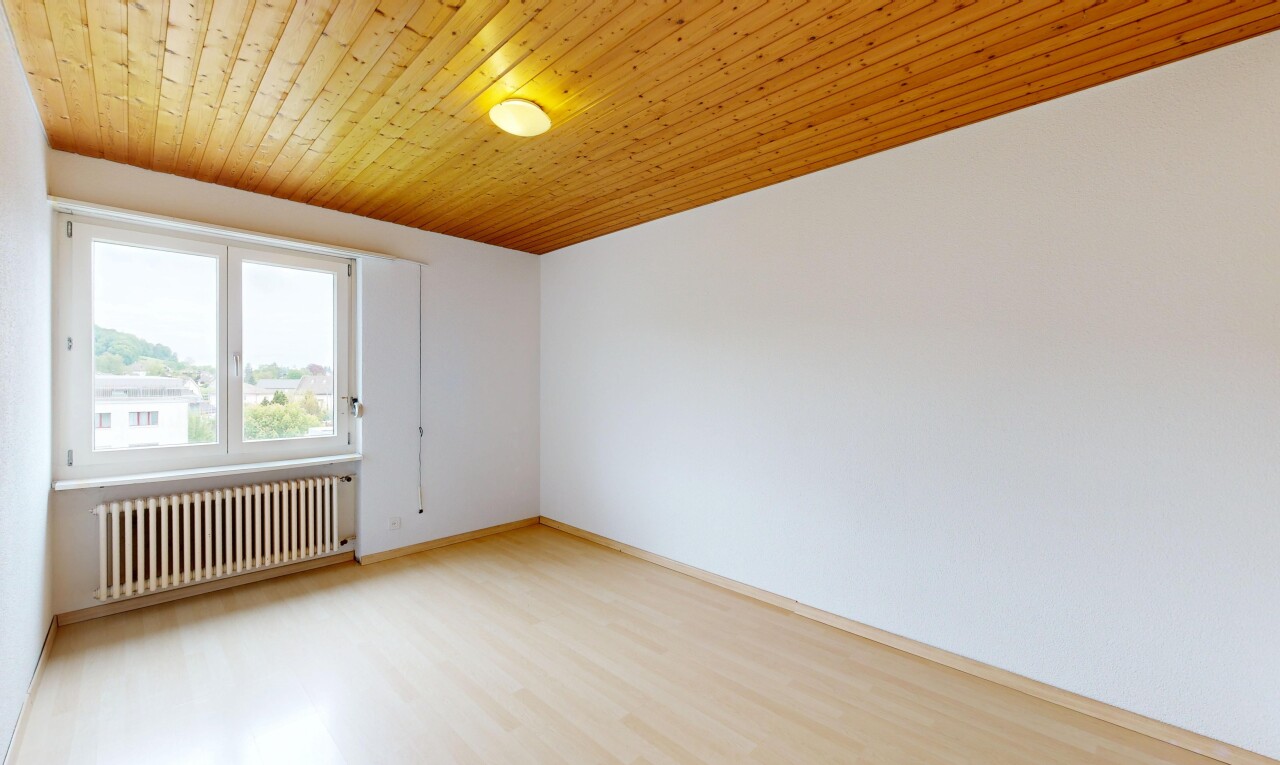 spare room with radiator heating unit, wooden ceiling, and light wood finished floors