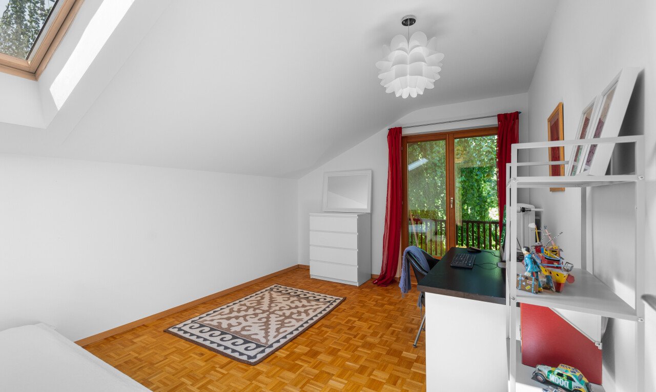 room with parquet flooring, vaulted ceiling, and a skylight