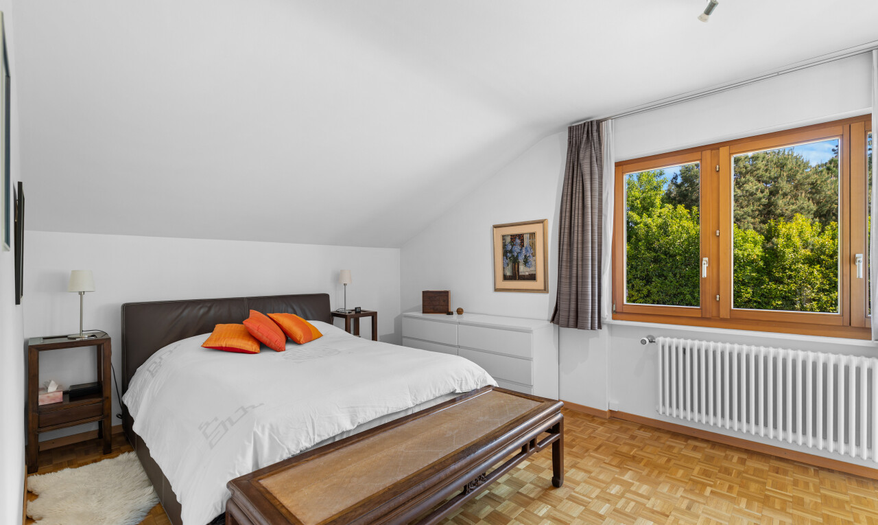 room with parquet flooring, radiator heating unit, and lofted ceiling