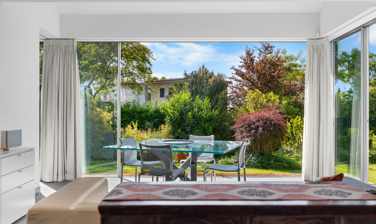 terrace with outdoor dining area and a sunroom