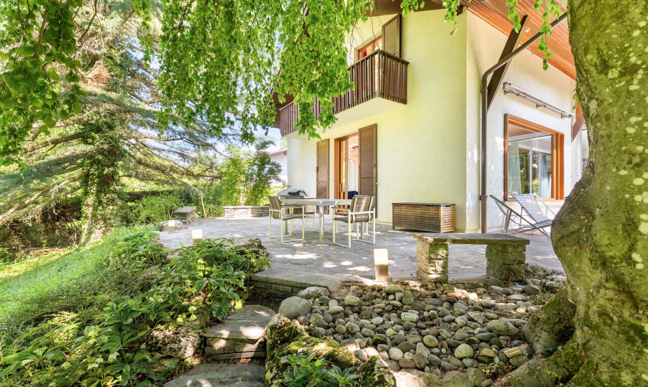 garden featuring a balcony, a patio area, and outdoor dining area