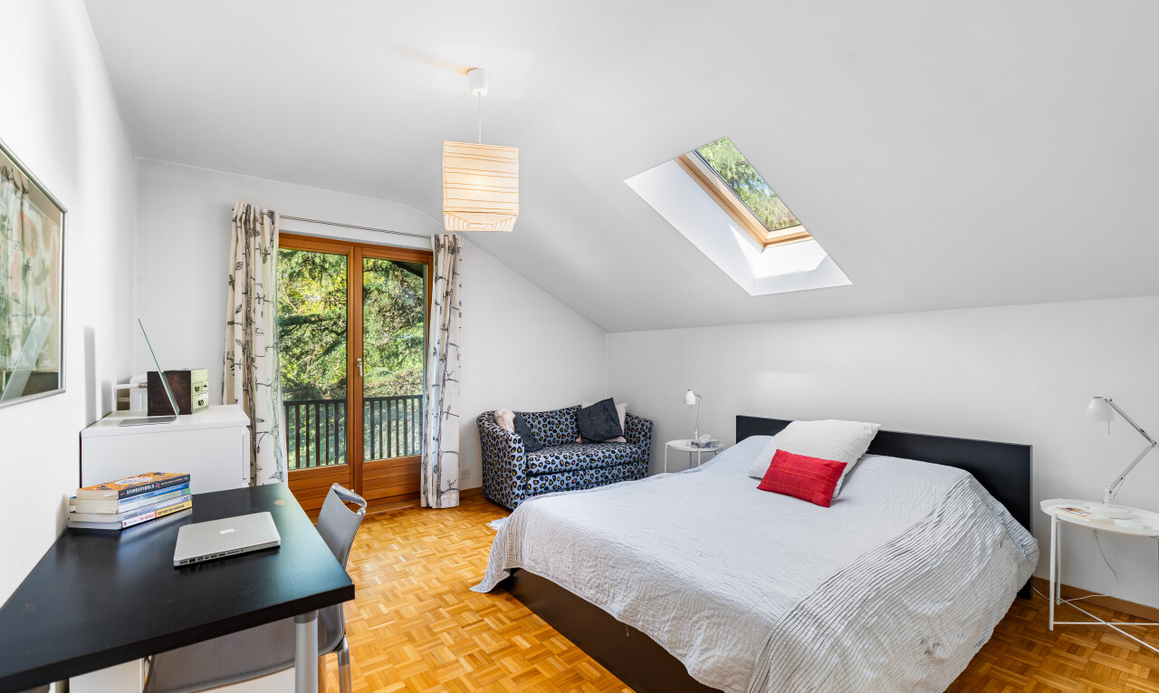 room with vaulted ceiling, parquet flooring, a desk, and a skylight