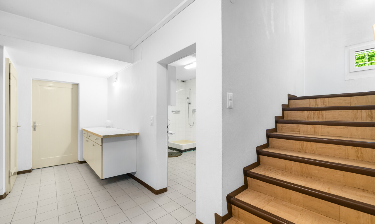 staircase featuring baseboards