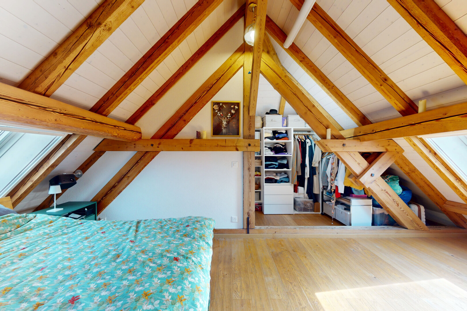 room / bedroom featuring wood finished floors, wooden ceiling, and a walk in closet