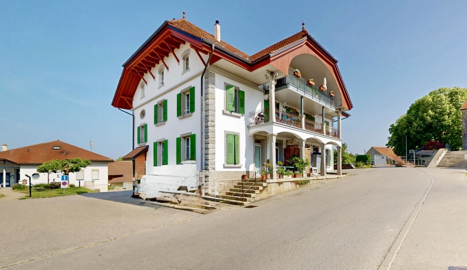 outdoor house with a balcony, a chimney, and a porch