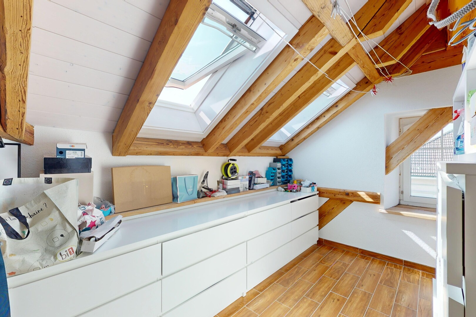kitchen featuring a skylight, lofted ceiling, and light wood-type flooring