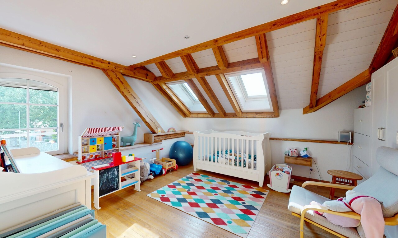 room / bedroom with a skylight and wood finished floors