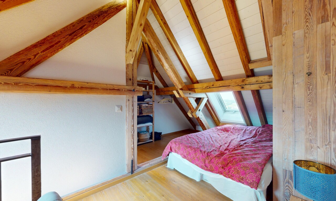 room / bedroom with wood finished floors and a skylight