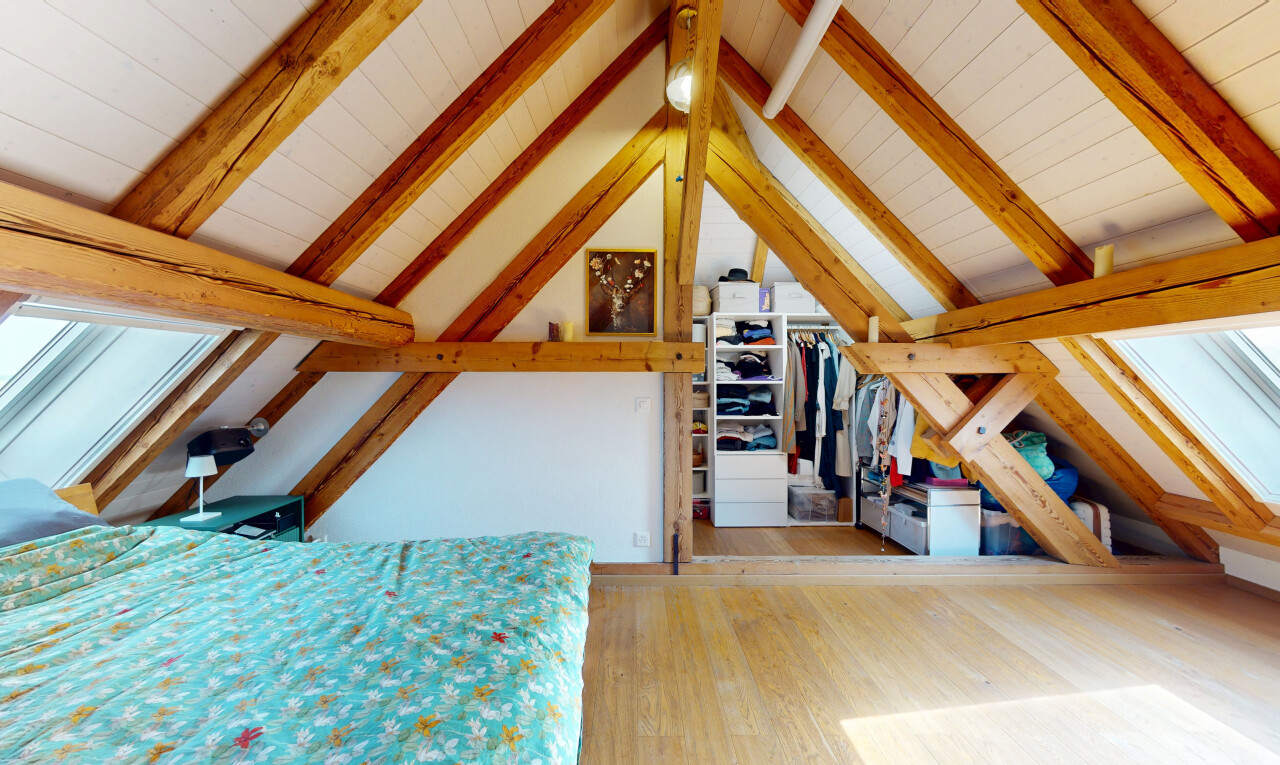 room / bedroom featuring wood finished floors, wooden ceiling, and a walk in closet