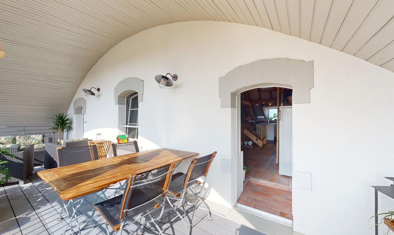 dining space featuring arched walkways and vaulted ceiling