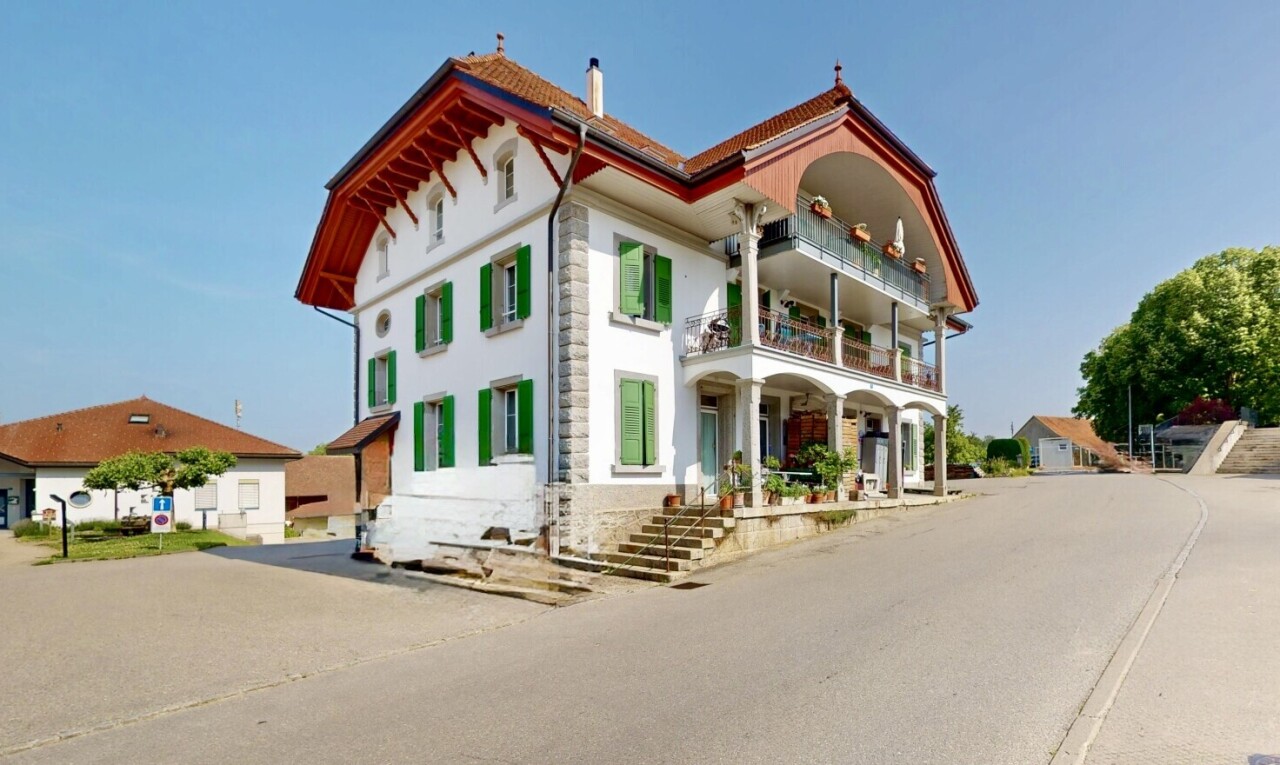 outdoor house with a balcony, a chimney, and a porch
