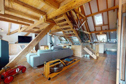 living room featuring stairway and beamed ceiling
