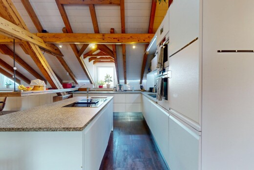 kitchen with white cabinetry, light countertops, dark wood finished floors, and black electric cooktop