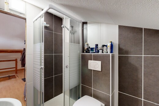 bathroom with a stall shower, a textured ceiling, and a bidet