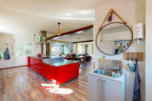 kitchen with light wood-style floors, island range hood, decorative light fixtures, and modern cabinets