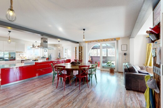 dining area with light wood finished floors, healthy amount of natural light, and beamed ceiling
