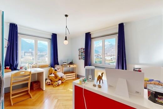 kitchen with parquet floors, decorative light fixtures, an office area, and light countertops