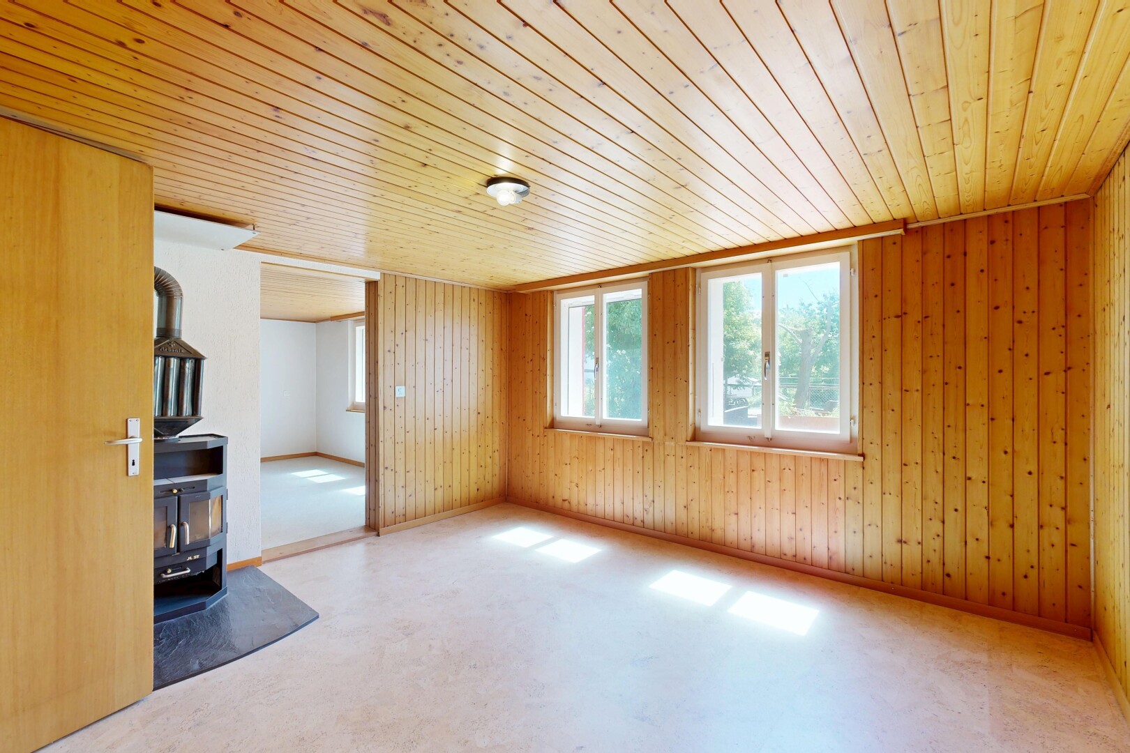 unfurnished room with wooden ceiling and wooden walls