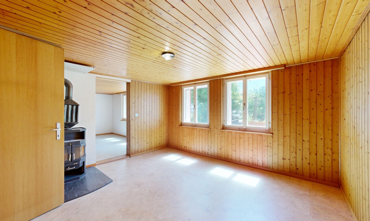 unfurnished room with wooden ceiling and wooden walls